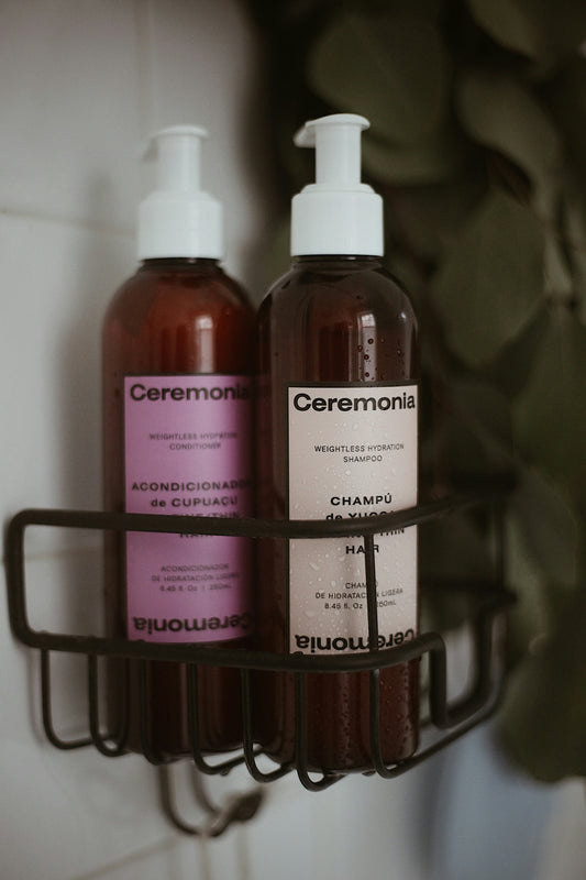 two bottles of shampoo and lotion sitting on a shelf